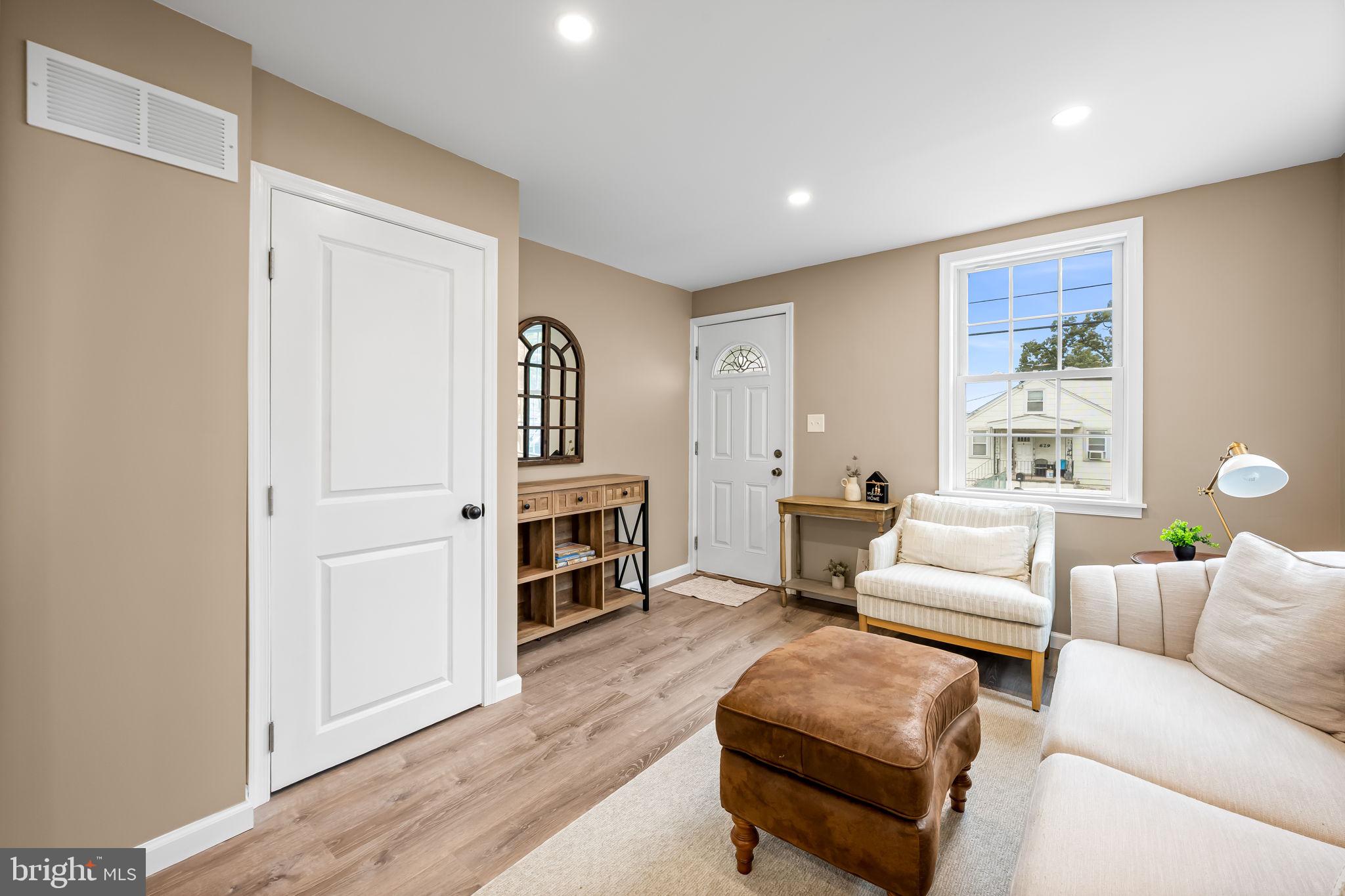 628 North Stuart Street Baltimore, MD 21221 - Photo 7 of 39 a living room with furniture and a fireplace