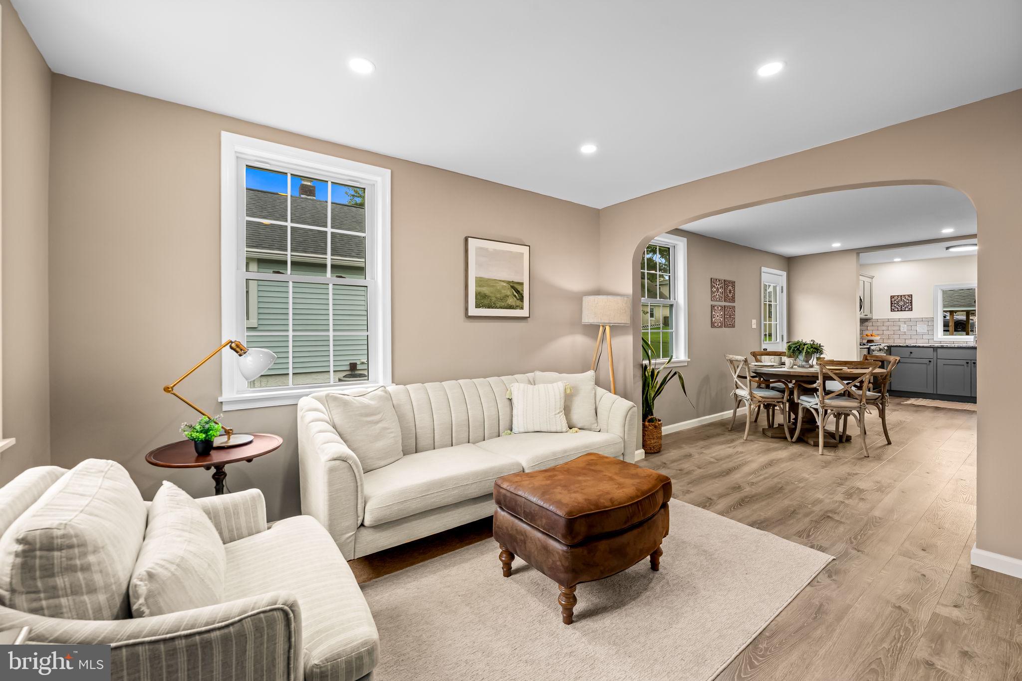 628 North Stuart Street Baltimore, MD 21221 - Photo 8 of 39 a living room with furniture and a dining table with rug
