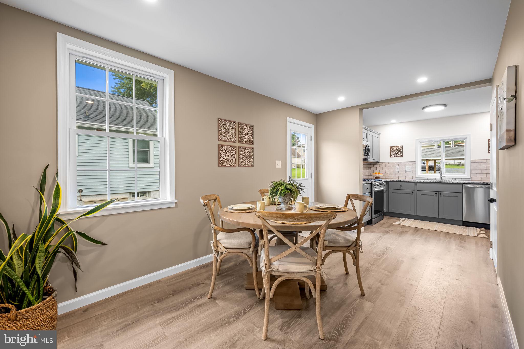 628 North Stuart Street Baltimore, MD 21221 - Photo 10 of 39 a view of a dining room with furniture and a potted plant