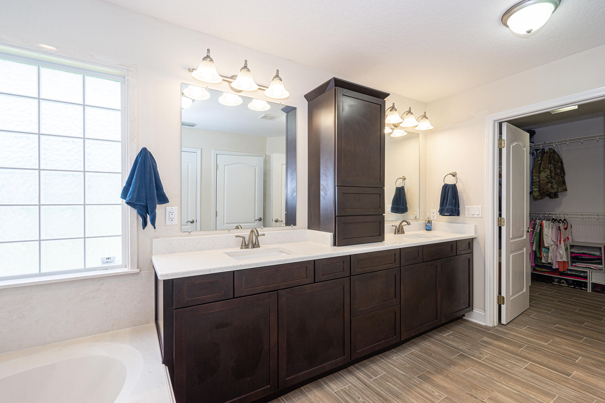 569 Radiant Circle Mary Esther, FL 32569 - Photo 17 of 42 a bathroom with a double vanity sink and a mirror