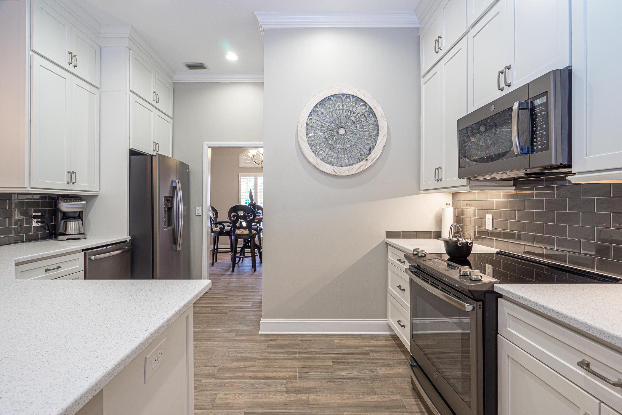 569 Radiant Circle Mary Esther, FL 32569 - Photo 7 of 42 a kitchen with stainless steel appliances granite countertop a refrigerator a stove top oven a sink and dishwasher