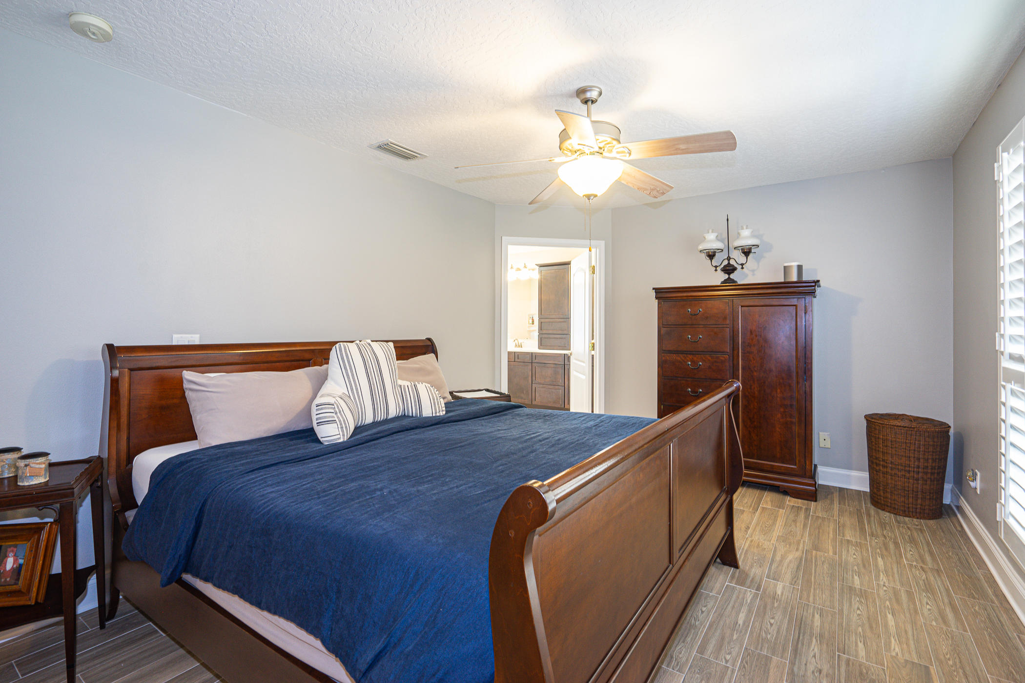 569 Radiant Circle Mary Esther, FL 32569 - Photo 10 of 42 a bed room with a bed and a chandelier