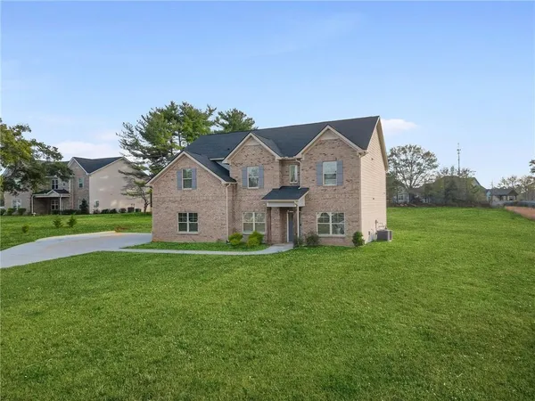 a front view of house with yard and green space