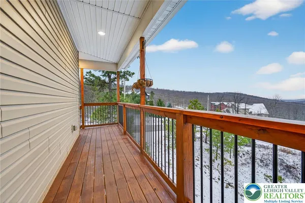 a kitchen with stainless steel appliances kitchen island granite countertop a stove and a wooden floor