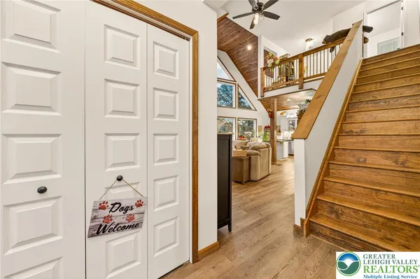 a view of a hallway with wooden floor and closet