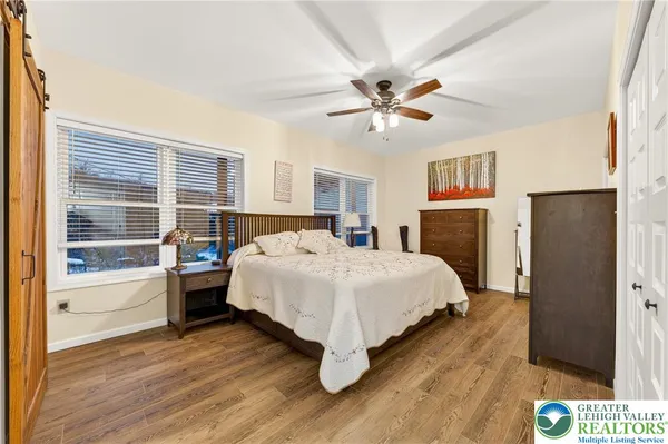 a bedroom with a bed and a ceiling fan