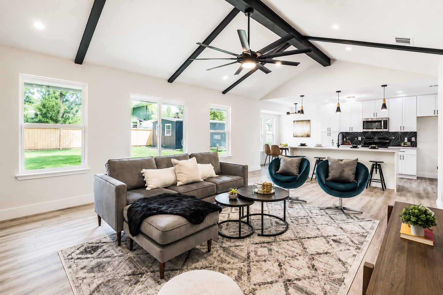 7500 Rio Pass Austin, TX 78724 - Photo 14 of 15 Exposed dark beams highlight the vaulted ceiling above a modern open-concept floor plan.