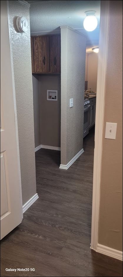 349 State Highway 95 Elgin, TX 78621 - Photo 11 of 16 Corridor featuring dark wood-style floors and a textured wall