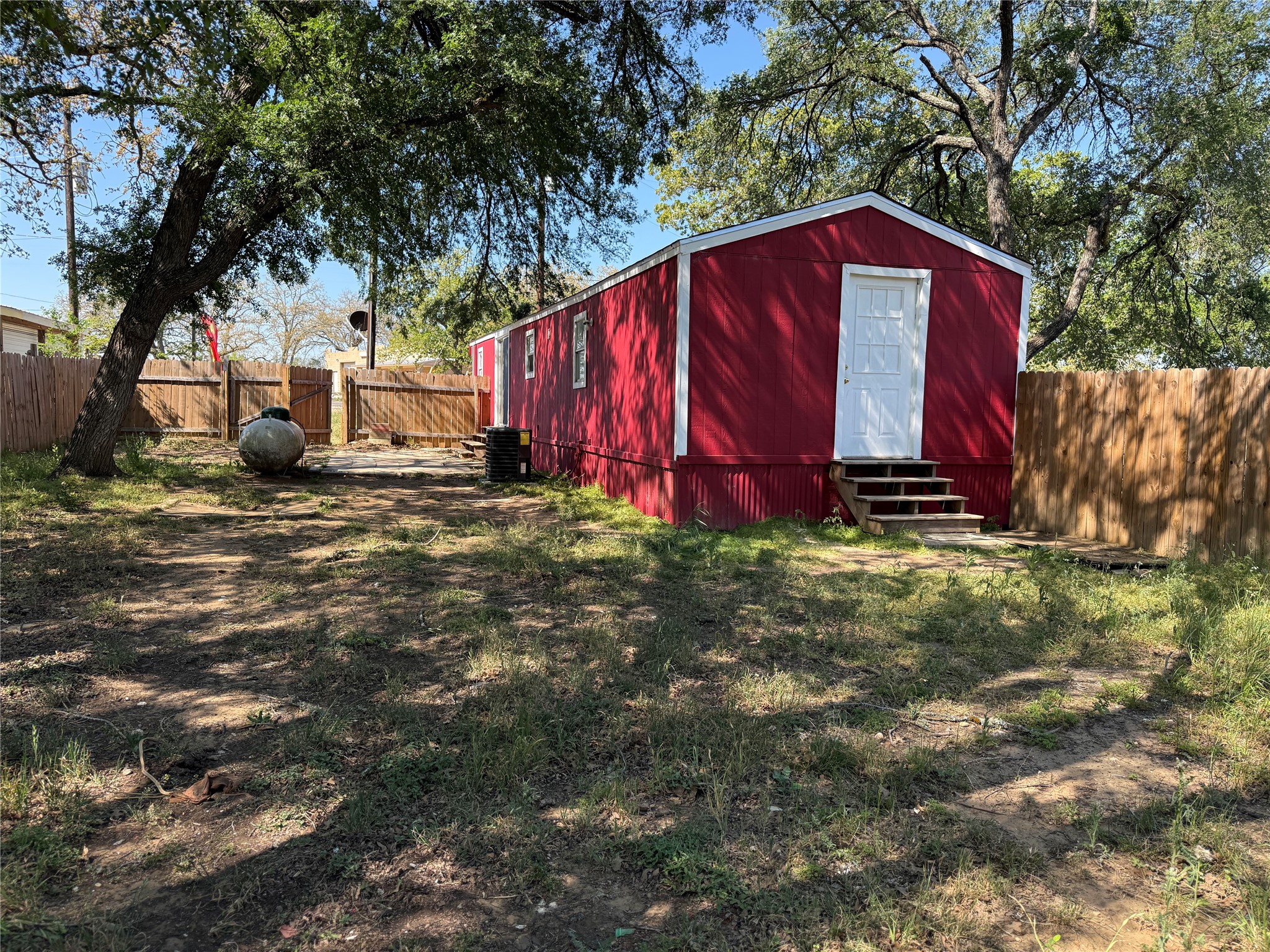 349 State Highway 95 Elgin, TX 78621 - Photo 12 of 16 View of outdoor structure with a fenced backyard and entry steps