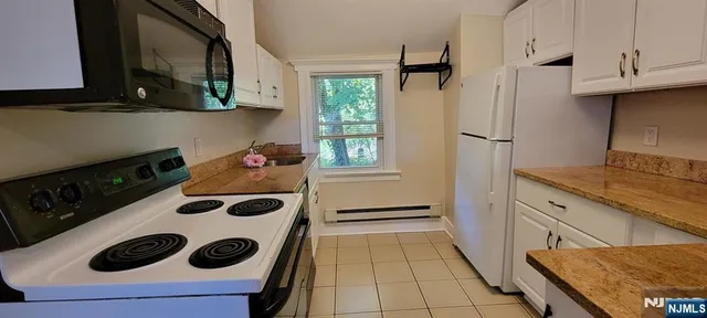 a kitchen with stainless steel appliances a stove a sink and a refrigerator