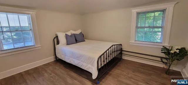 a bed sitting in a bedroom next to a window