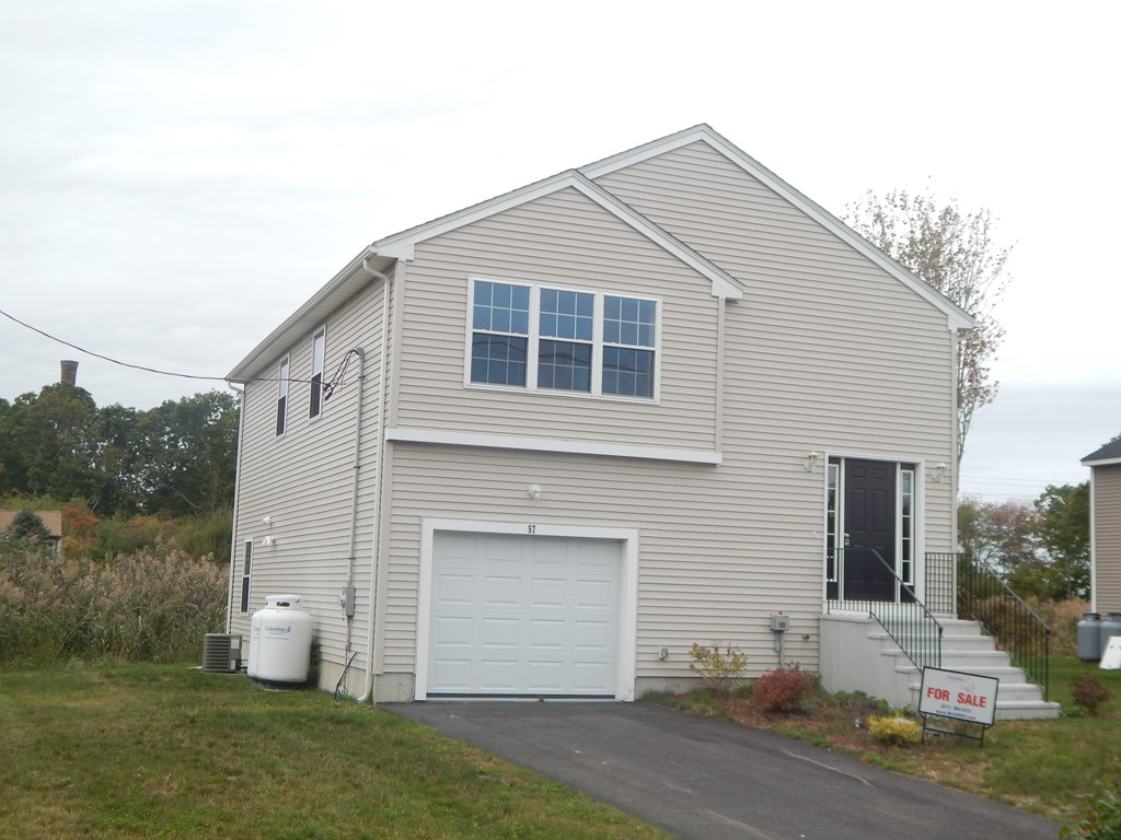 57 Frederick Street Fall River, MA 02721 - Photo 1 of 13 a front view of a house with a yard