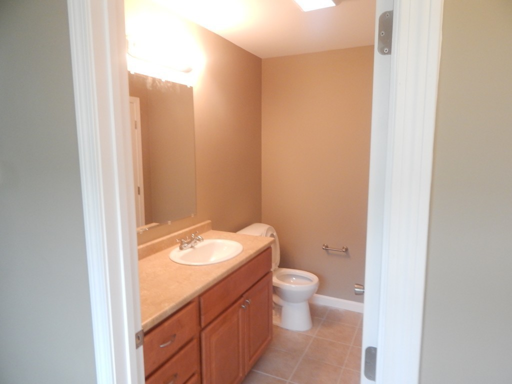 57 Frederick Street Fall River, MA 02721 - Photo 11 of 13 a bathroom with a granite countertop toilet and a sink