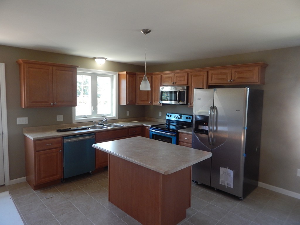57 Frederick Street Fall River, MA 02721 - Photo 3 of 13 a kitchen with stainless steel appliances granite countertop a sink stove and refrigerator