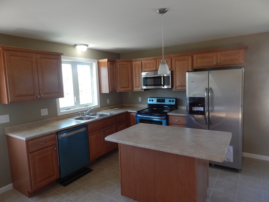 57 Frederick Street Fall River, MA 02721 - Photo 4 of 13 a kitchen with kitchen island granite countertop a sink stainless steel appliances and window