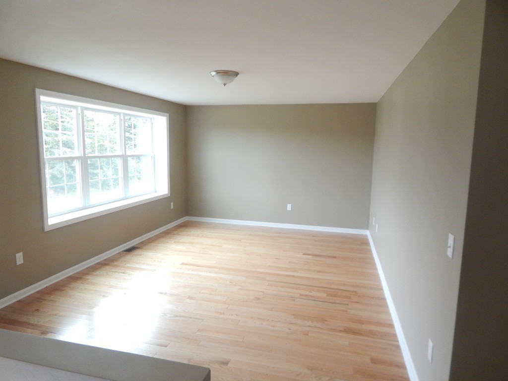 57 Frederick Street Fall River, MA 02721 - Photo 7 of 13 an empty room with wooden floor and windows
