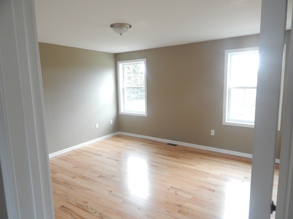 57 Frederick Street Fall River, MA 02721 - Photo 10 of 13 a view of an empty room with wooden floor and a window