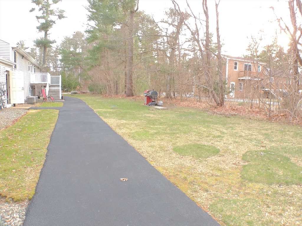 1 Gault Road, Unit 6 West Wareham, MA 02576 - Photo 8 of 9 a view of swimming pool with lawn chairs and large trees
