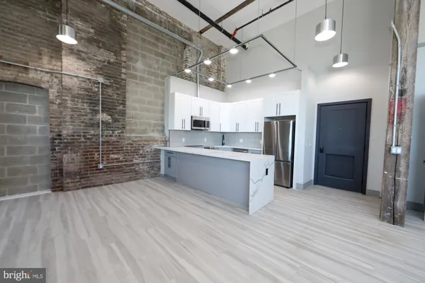 a large kitchen with cabinets and stainless steel appliances