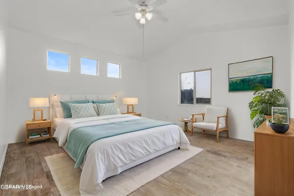 a kitchen with stainless steel appliances granite countertop a stove a refrigerator a sink a microwave oven and a window with wooden floor