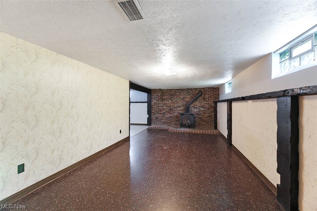 7090 Liberty Road Solon, OH 44139 - Photo 14 of 21 Finished lower level offers a large rec room with wood burning stove and a 4th bedroom or office space