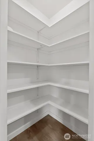 a view of walk in closet with empty racks