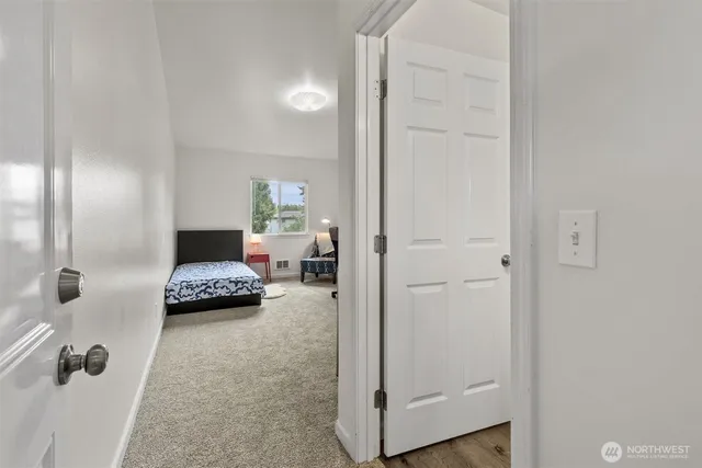 a bedroom with a bed and a view of bathroom