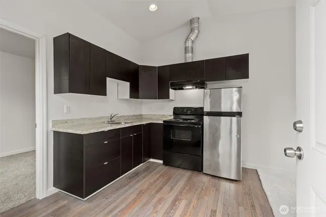 a kitchen with a refrigerator and a sink