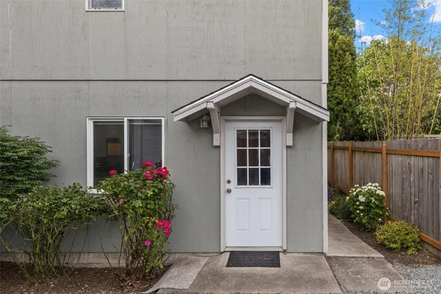 a front view of a house with plants