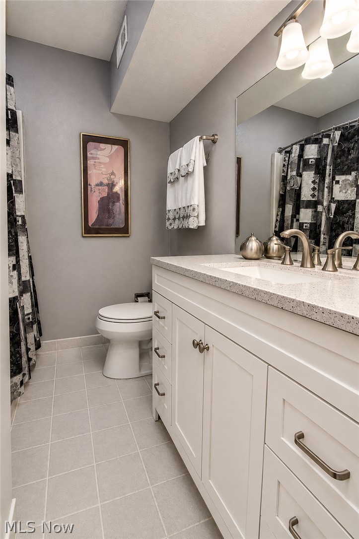 16575 Wren Road, Unit 3C Chagrin Falls, OH 44023 - Photo 22 of 29 Updated In-suite full bathroom, 4 ft white vanity, solid countertop. Mirrors and light fixtures replaced.
