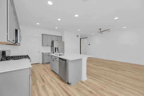 a view of a kitchen with a sink and cabinets