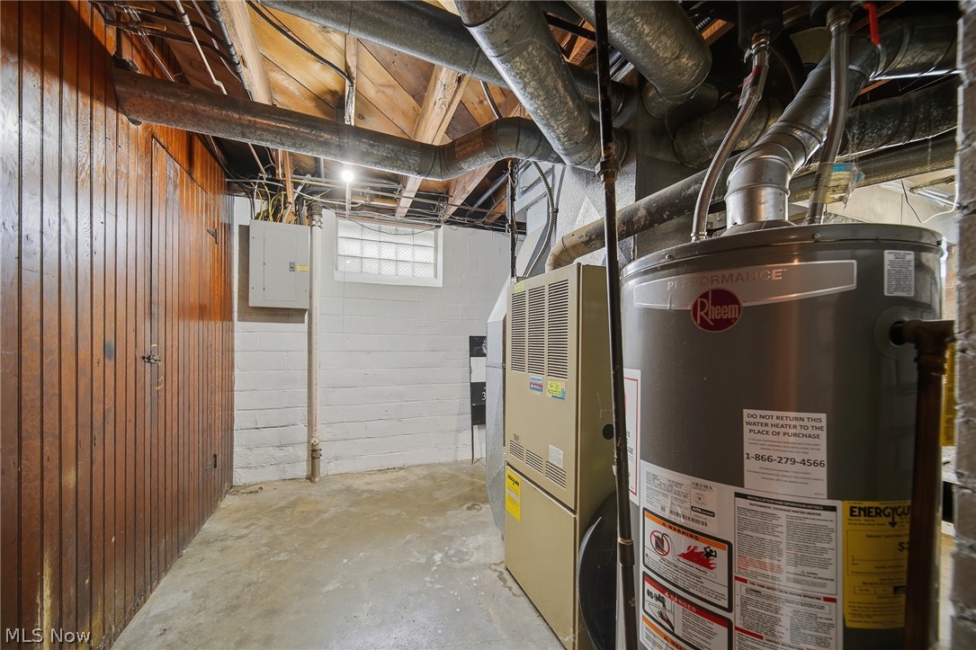 2231 Brockway Road University Heights, OH 44118 - Photo 33 of 46 Basement area featuring a water heater, furnace, exposed ceiling joists, and a glass block window