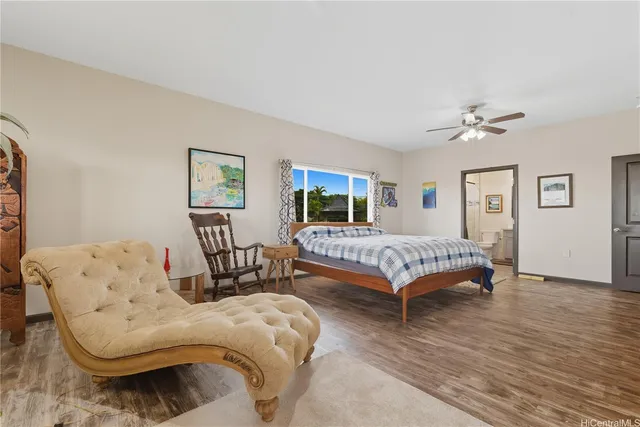 a bedroom with a bed couch and window