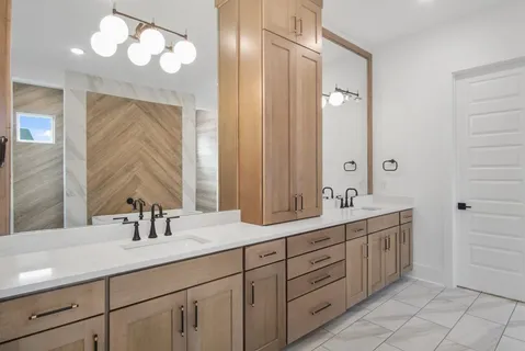 a bathroom with a tub a sink and mirror
