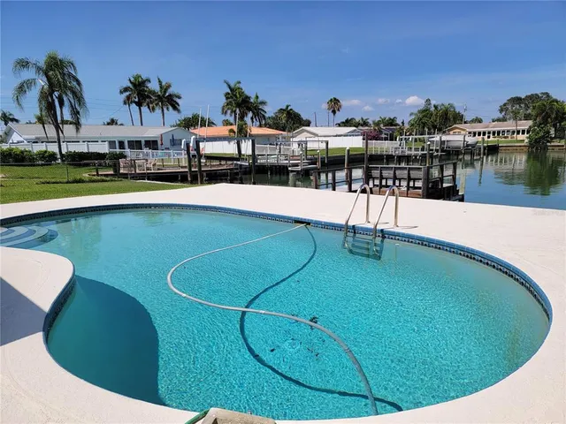 a view of a swimming pool with outdoor seating
