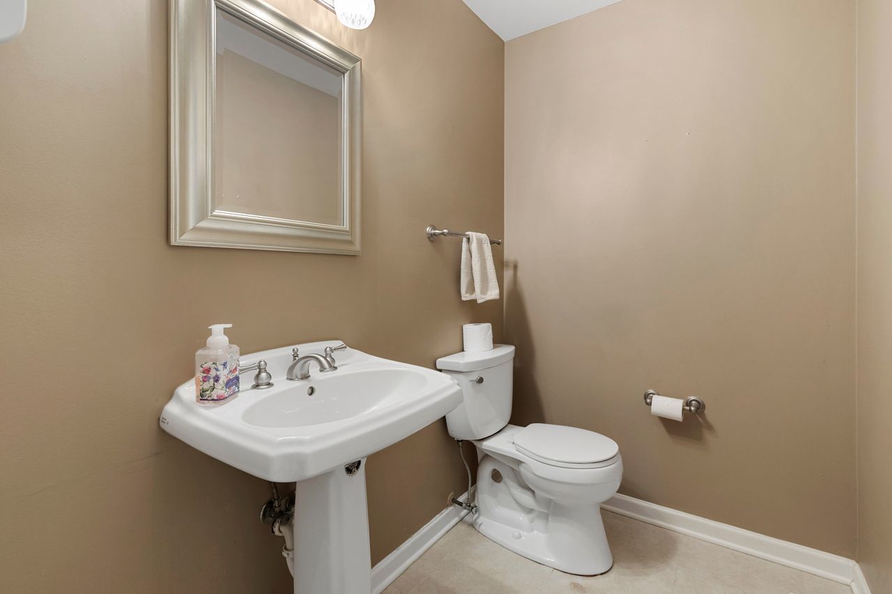 681 Randi Lane Hoffman Estates, IL 60169 - Photo 13 of 33 a bathroom with a toilet sink and mirror