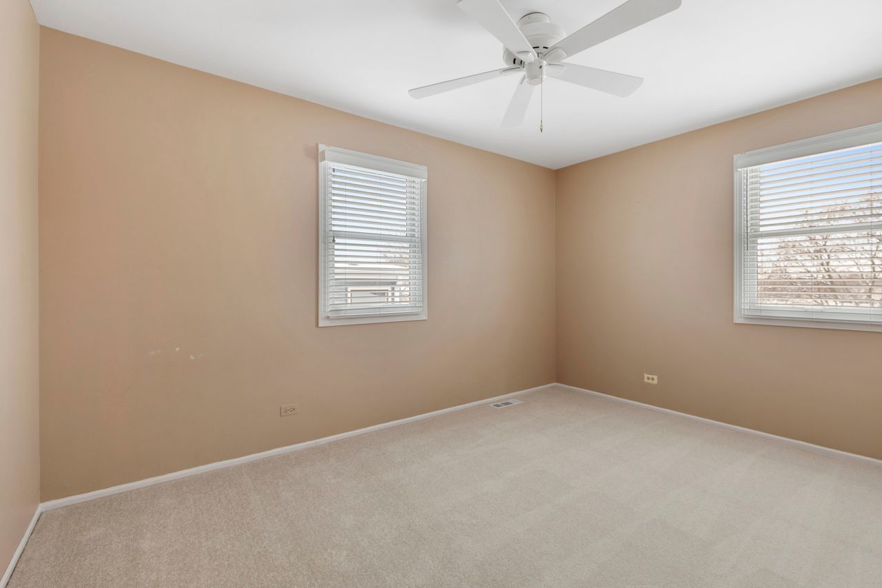 681 Randi Lane Hoffman Estates, IL 60169 - Photo 18 of 33 an empty room with windows and fan