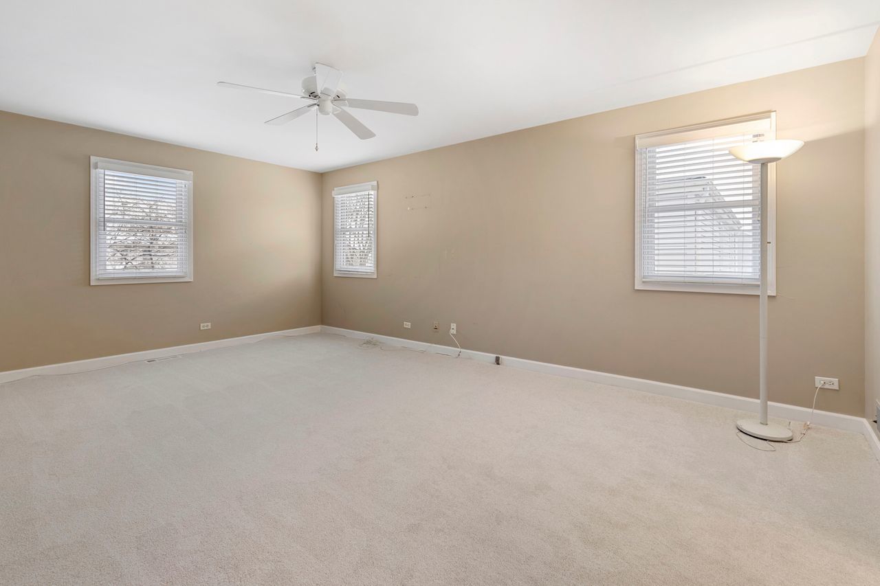 681 Randi Lane Hoffman Estates, IL 60169 - Photo 23 of 33 an empty room with windows and fan