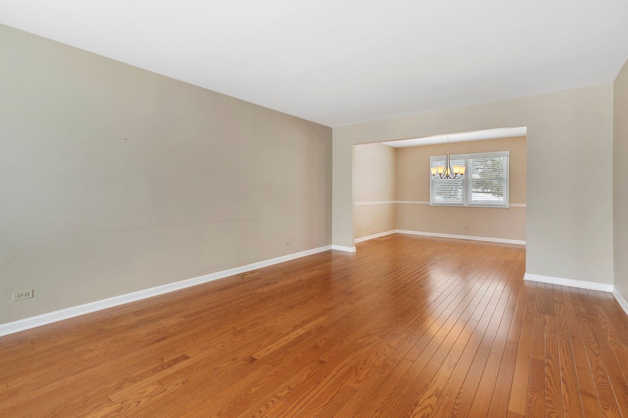 681 Randi Lane Hoffman Estates, IL 60169 - Photo 7 of 33 an empty room with wooden floor and windows