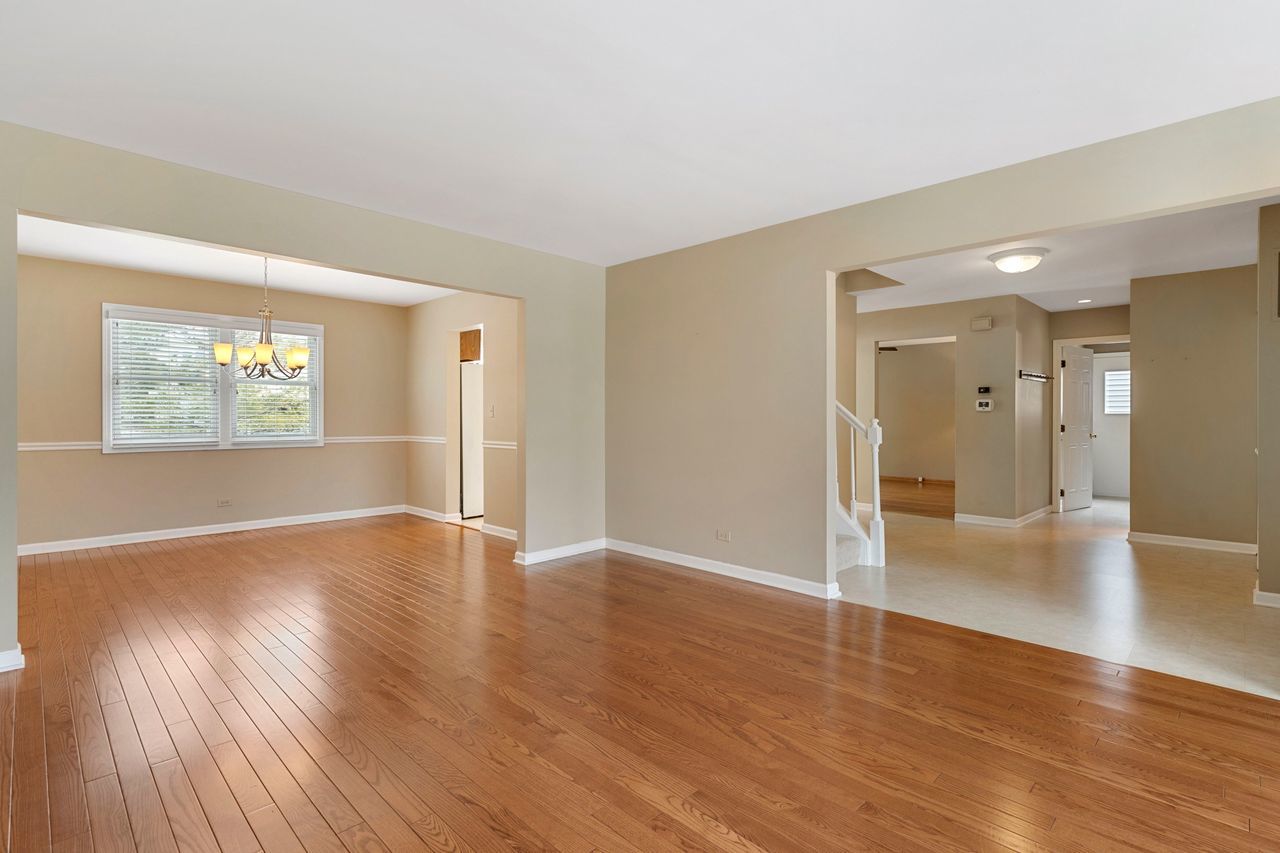 681 Randi Lane Hoffman Estates, IL 60169 - Photo 8 of 33 an empty room with wooden floor and windows
