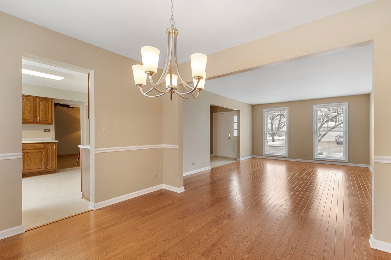 681 Randi Lane Hoffman Estates, IL 60169 - Photo 10 of 33 a view of an empty room with wooden floor and a window