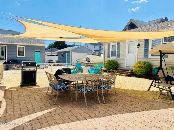 a view of a patio with table and chairs
