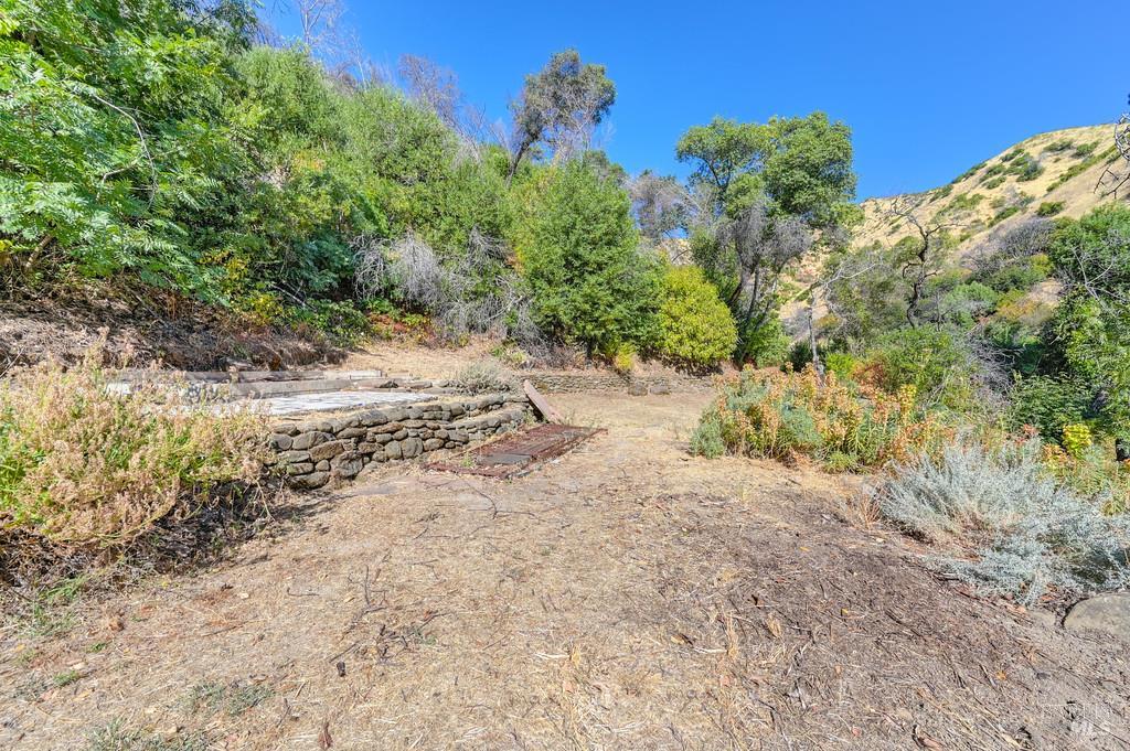 2985 Mix Canyon Road Vacaville, CA 95688 - Photo 20 of 34 a view of a dirt road with plants and large trees
