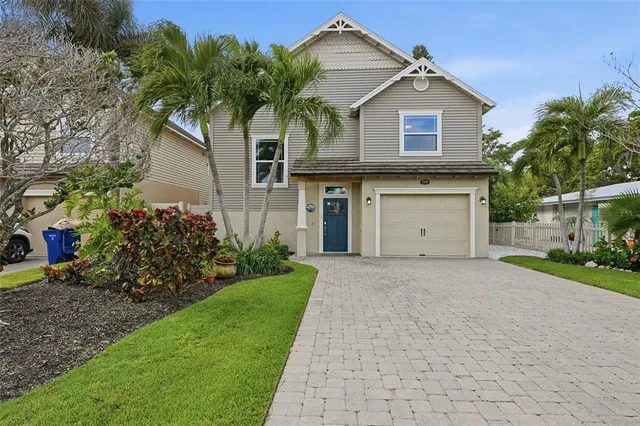 a front view of a house with a garden and plants