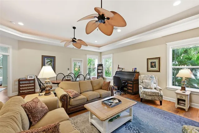a living room with furniture ceiling fan and a rug