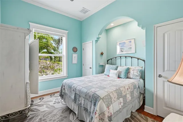 a bedroom with a bed and a window