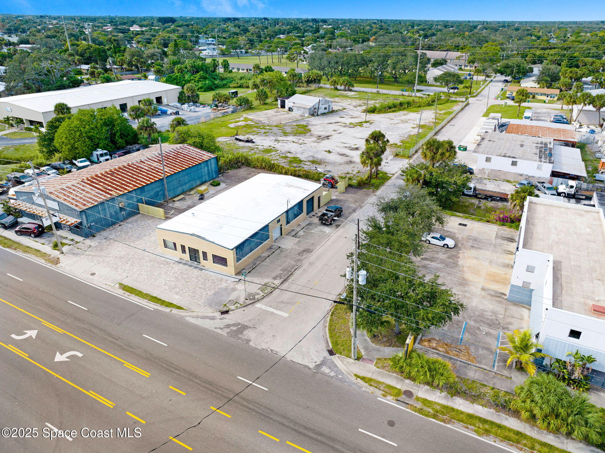 1075 Mcclendon Street Melbourne, FL 32935 - Photo 18 of 24 an aerial view of a city with lots of residential buildings and mountain view in back