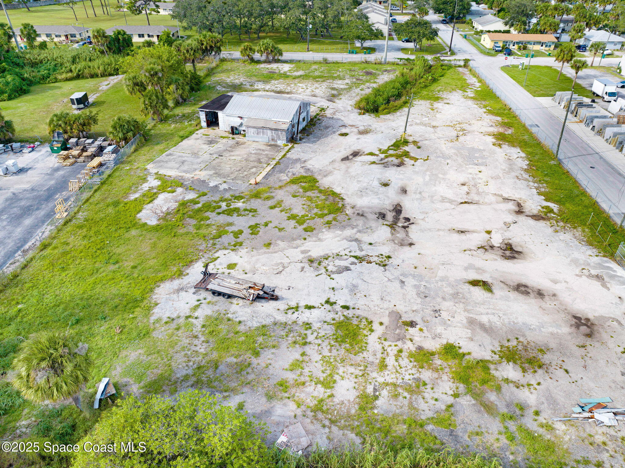 1075 Mcclendon Street Melbourne, FL 32935 - Photo 8 of 24 a view of a lake with beach and houses
