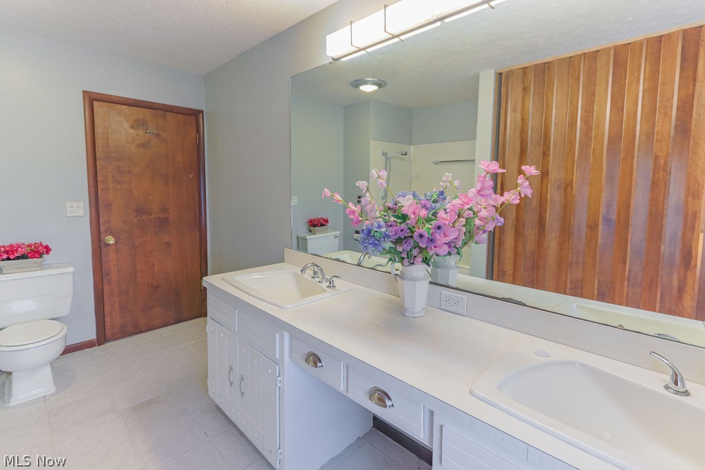 51883 Telegraph Road Amherst, OH 44001 - Photo 12 of 49 Bathroom featuring vanity, a textured ceiling, and toilet