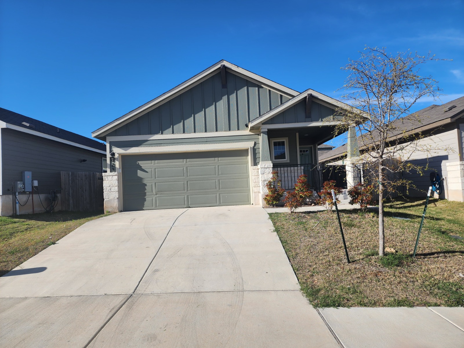 623 Sungrove Trail Georgetown, TX 78628 - Photo 1 of 17 Craftsman house featuring board and batten siding, a front lawn, a garage, and concrete driveway